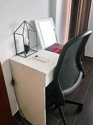 a desk with a chair and a lamp on it at Youthfull Escape in Nicosia in Nicosia