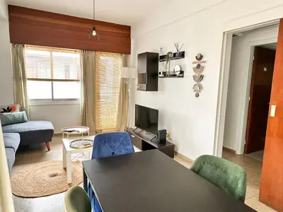a living room with a table and chairs at Youthfull Escape in Nicosia in Nicosia