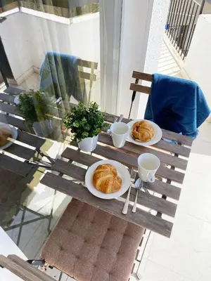 a wooden table with plates of pastries on it at Cozy place in Larnaka