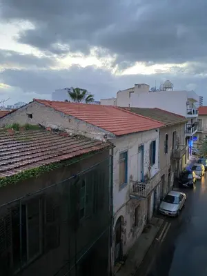 a view of a street with buildings and cars at Cozy place in Larnaka