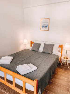 a bedroom with a large bed with two towels on it at Cozy place in Larnaka