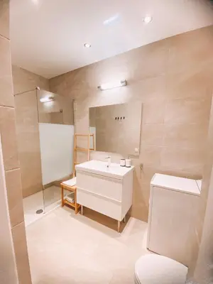 a bathroom with a white sink and a mirror at Cozy place in Larnaka