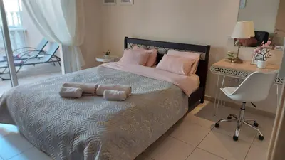 a bedroom with a bed with two towels on it at Nissi Golden Sands Holiday Apartment Free WiFi in Ayia Napa