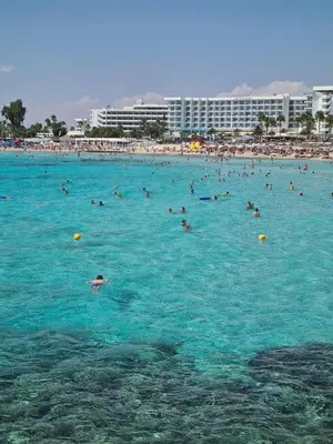 a group of people in the water at a beach at Nissi Golden Sands Holiday Apartment Free WiFi in Ayia Napa