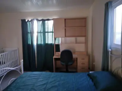 a bedroom with a bed and a desk and a chair at MERSINERA Paradise Garden 2 in Larnaka