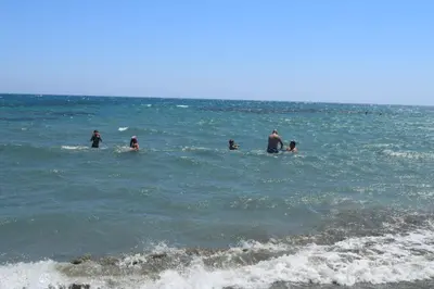 a group of people swimming in the ocean at MERSINERA Paradise Garden 2 in Larnaka