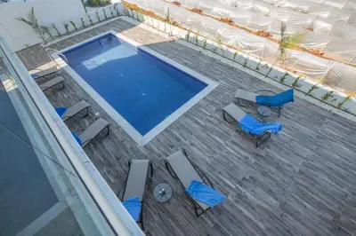an overhead view of a swimming pool with chairs and a table at Protaras Olivine Villa OL17 in Protaras