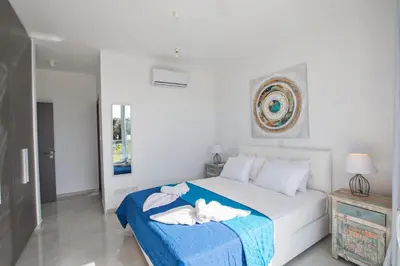 a bedroom with a bed with towels on it at Olivine 3 Bedroom Villas in Protaras