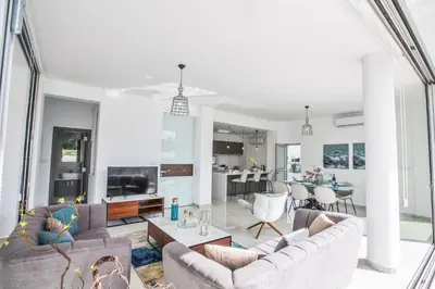 a living room with two couches and a dining room at Olivine 3 Bedroom Villas in Protaras
