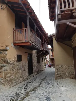 an alley with a balcony on the side of a building at Irene's House in Kakopetria
