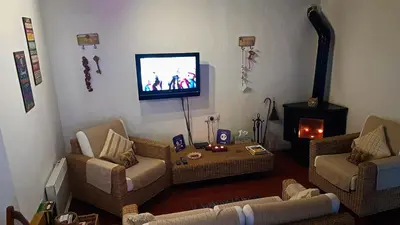 a living room with couches and a tv in the corner at Irene's House in Kakopetria