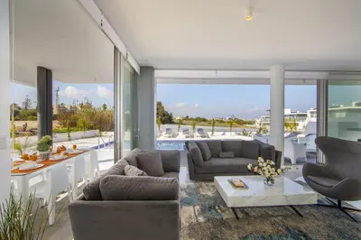 a living room with couches and a table at Protaras Olivine Pearl in Protaras
