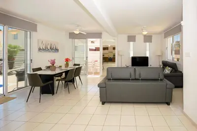 a living room with a couch and a table at Villa Blue Sky in Protaras
