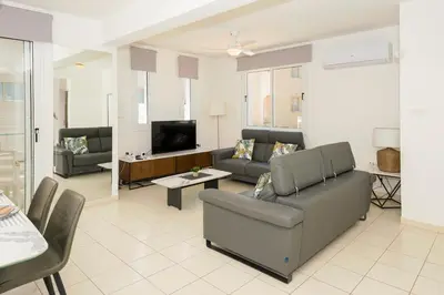 a living room with a couch and a tv at Villa Blue Sky in Protaras