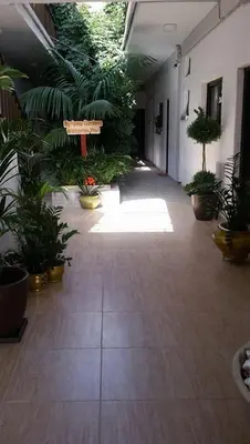 a hallway of a building with plants and a bench at Myriama Apartments in Ayia Napa