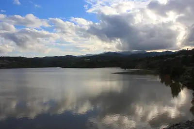 a large body of water with mountains in the background at Aperanti Agrotourism in Pera Orinis