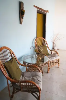 a room with two chairs and a table and a table and chairs at Aperanti Agrotourism in Pera Orinis