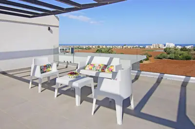 a rendering of a patio with white chairs and a table at Villa Amelia in Paralimni