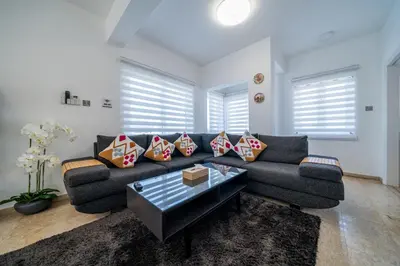 a living room with a couch and a coffee table at Dene Hollow Oroklini in Voroklini