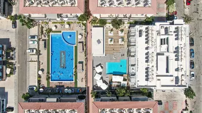 an overhead view of a city with a swimming pool at Mythical Sands Resort - Maria in Protaras