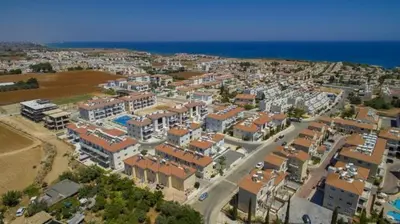 an aerial view of a city with buildings and the ocean at Mythical Sands Resort - Maria in Protaras