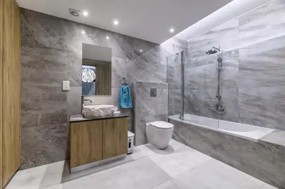 a bathroom with a tub and a toilet and a sink at Serenity Seafront Villa in Ayia Napa