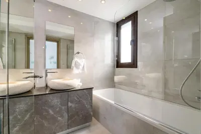 a bathroom with a tub and a sink at Serenity Seafront Villa in Ayia Napa