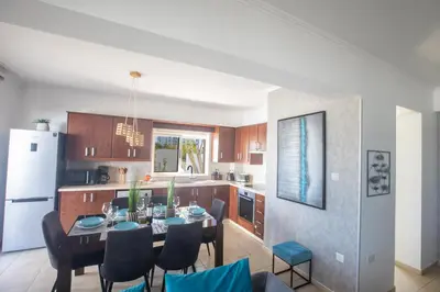 a kitchen and dining room with a table and chairs at Tonia Seaview Villas in Protaras