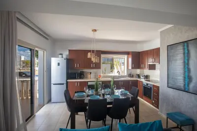 a kitchen and dining room with a table and chairs at Tonia Seaview Villas in Protaras