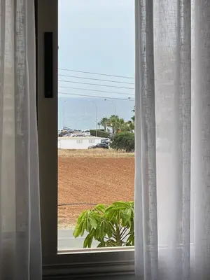 a window with a view of a beach at Tonia Seaview Villas in Protaras