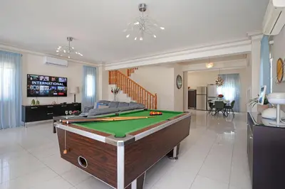 a living room with a pool table in it at Villa Oceania - Beachfront in Paralimni