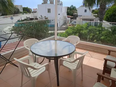 a glass table and chairs on a balcony at Larnaca, Pervolia 1 bedroom seaside apartment in Pervolia