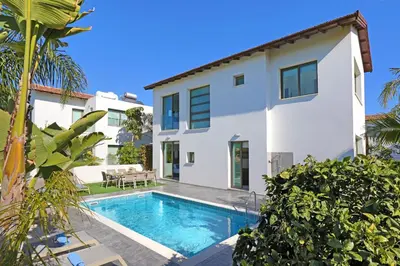 a villa with a swimming pool and a house at Villa Apollonia in Paralimni