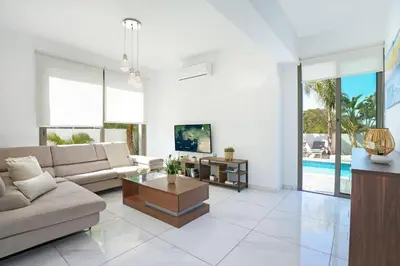 a living room with a couch and a table at Villa Apollonia in Paralimni