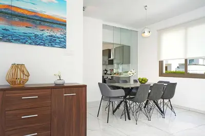 a kitchen and dining room with a table and chairs at Villa Apollonia in Paralimni