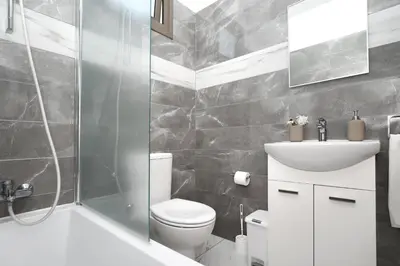 a bathroom with a toilet and a shower and a sink at Villa Apollonia in Paralimni