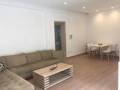 a living room with a couch and a table at Modern 2 bedroom Beach Apartment in Limassol
