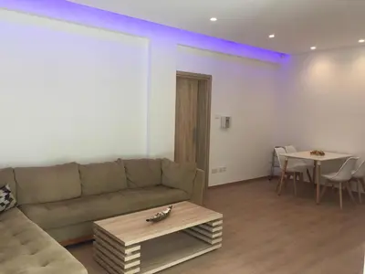 a living room with a couch and a table at Modern 2 bedroom Beach Apartment in Limassol