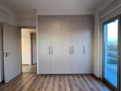 a room with white cabinets and a large window at River View Apartment in center Nicosia in Nicosia