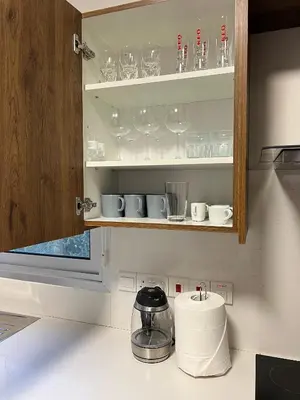 a kitchen with cups and glasses on shelves at River View Apartment in center Nicosia in Nicosia