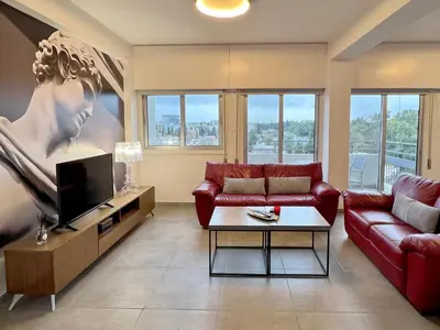 a living room with a couch and a tv at River View Apartment in center Nicosia in Nicosia
