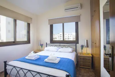 a bedroom with a bed with towels on it at Protaras Fig Tree Bay Villa Buena in Protaras