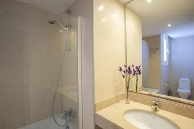 a bathroom with a sink and a shower and a toilet at Protaras Seafront Villa Infinte Aretousa in Protaras