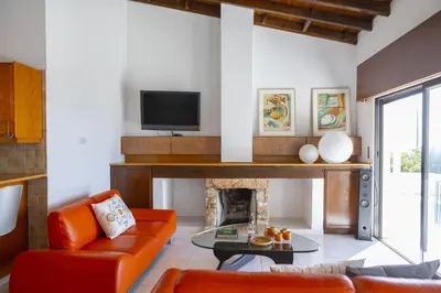 a living room with a couch and a fireplace at Ayia Napa Ammos Sea View Villa in Ayia Napa