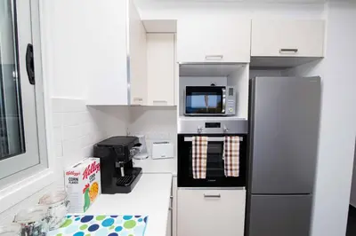 a kitchen with a refrigerator and a microwave at Apartment Trident 4 in Paralimni