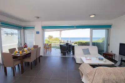 a living room with a couch and a table and chairs at Apartment Trident 4 in Paralimni