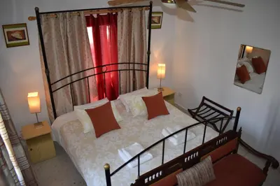 a bedroom with a large bed and a window at George Houses in Pendakomo
