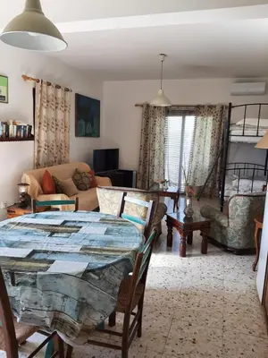a living room with a table and a couch at George Houses in Pendakomo