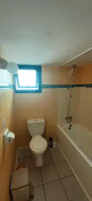 a bathroom with a toilet and a bath tub at Ayia Napa Sun Central in Ayia Napa