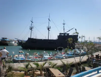 a large ship docked in a harbor with boats at Ayia Napa Sun Central in Ayia Napa
